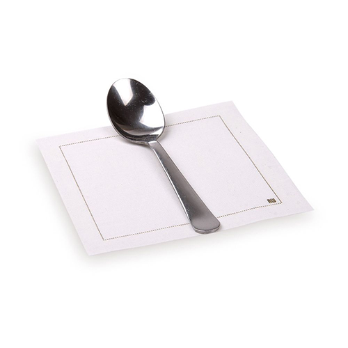 A compostable spoon on a Disposable Cotton Cocktail Napkin.